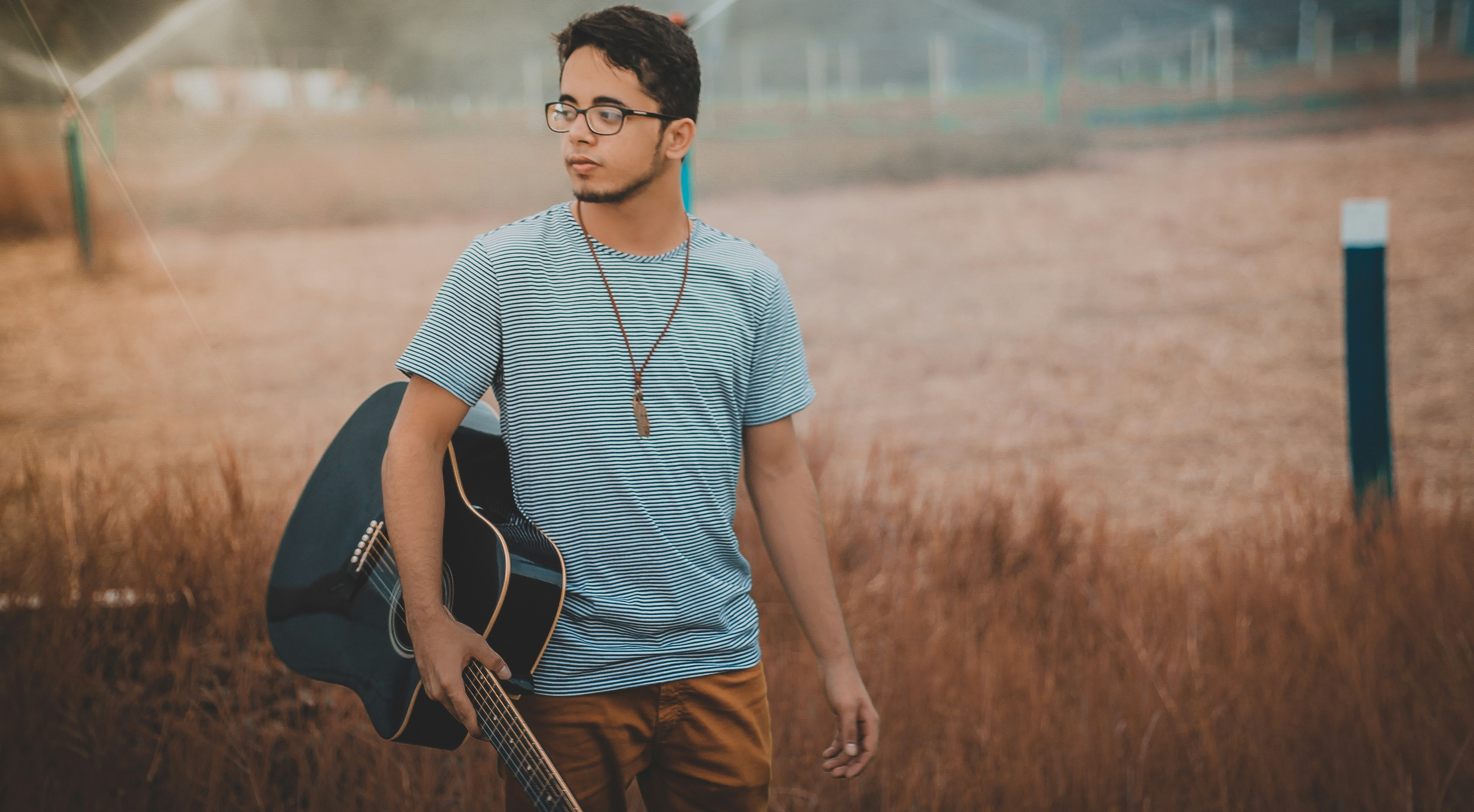 man holding cutwaya acoustic guitar